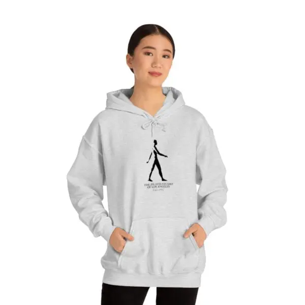 A woman is wearing a hoodie with a picture of a person walking.