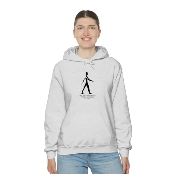 A woman wearing a white hoodie with a drawing of a person walking.