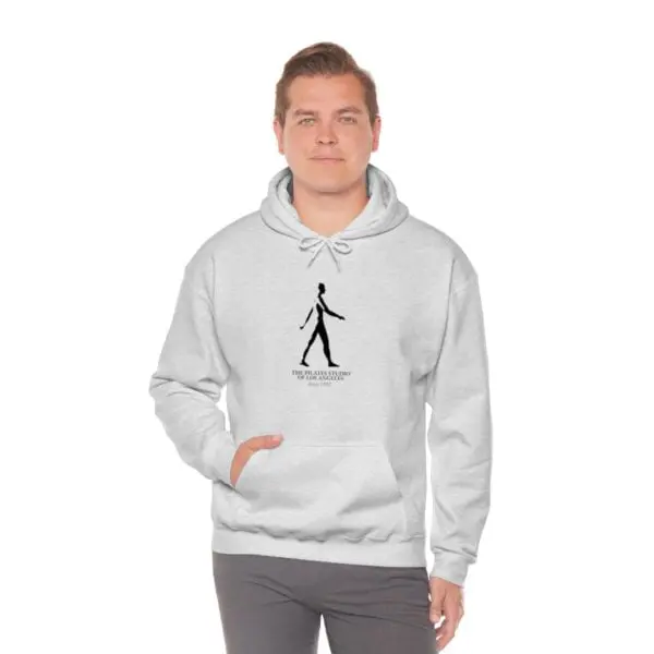 A man wearing a white hoodie with a black stick figure.