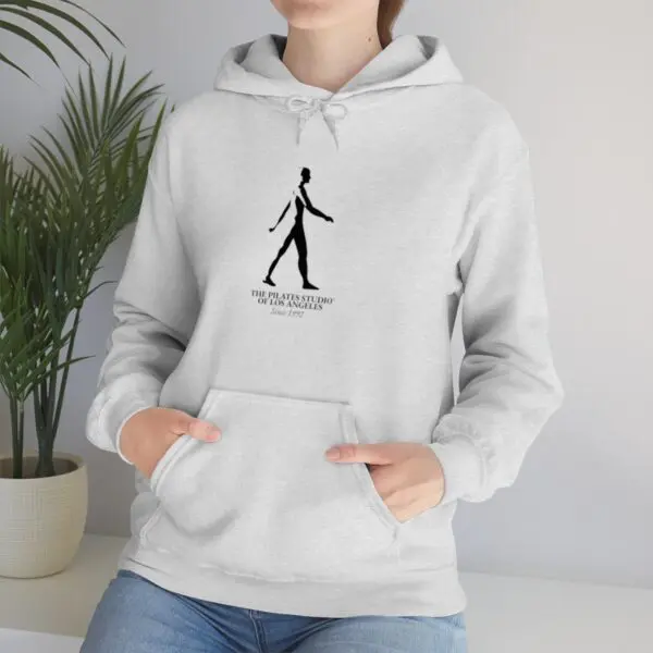 A person wearing a hoodie with a picture of a man walking.