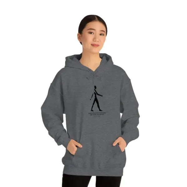 A woman is wearing a gray hoodie with a black design on it.