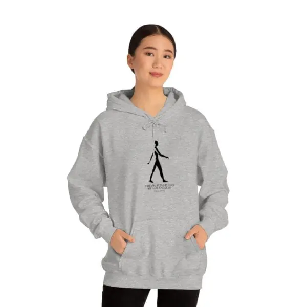 A woman is wearing a hoodie with a picture of a person walking.