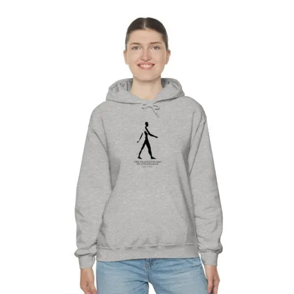 A woman wearing a gray hoodie with a black image of a person walking.