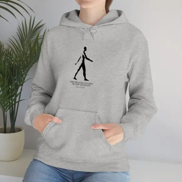 A person wearing a hoodie with a picture of a man walking.