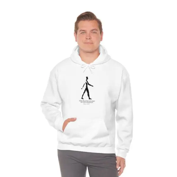 A man wearing a white hoodie with an image of a person walking.