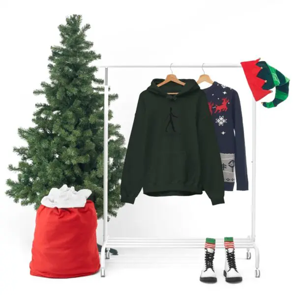 A christmas tree and clothes hanging on a rack.