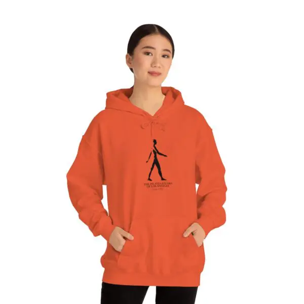 A woman in an orange hoodie with a black figure on it.