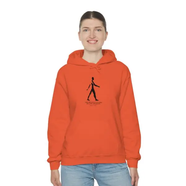 A person wearing an orange hoodie with a black design