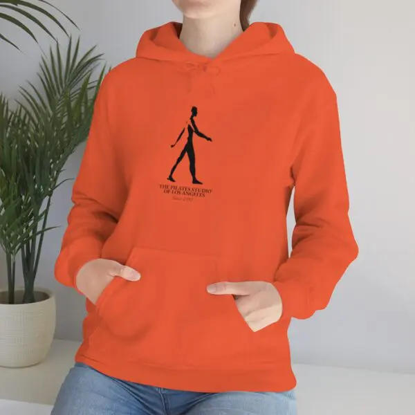 A person wearing an orange hoodie with a stick figure