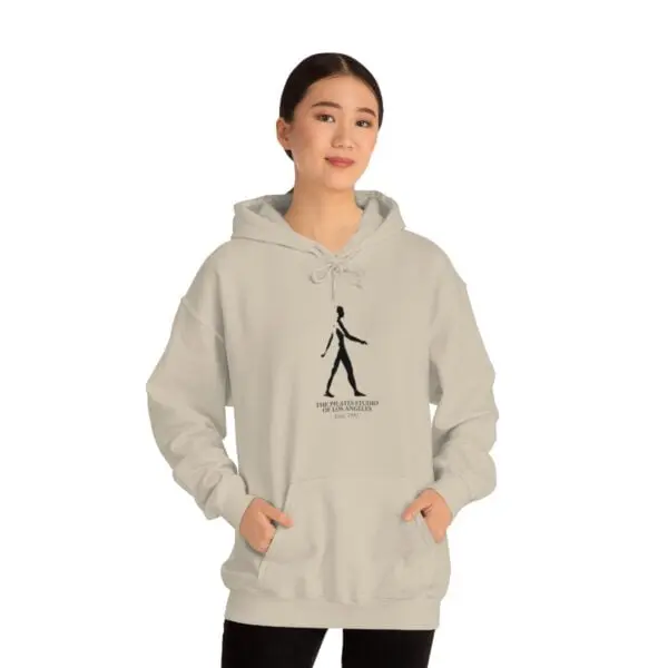 A woman wearing a hoodie with an image of a person walking.