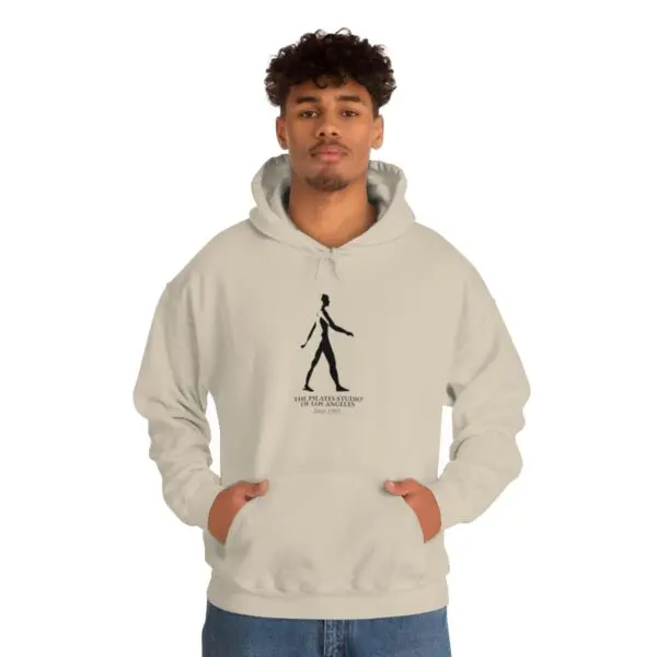 A man in a white hoodie is standing up