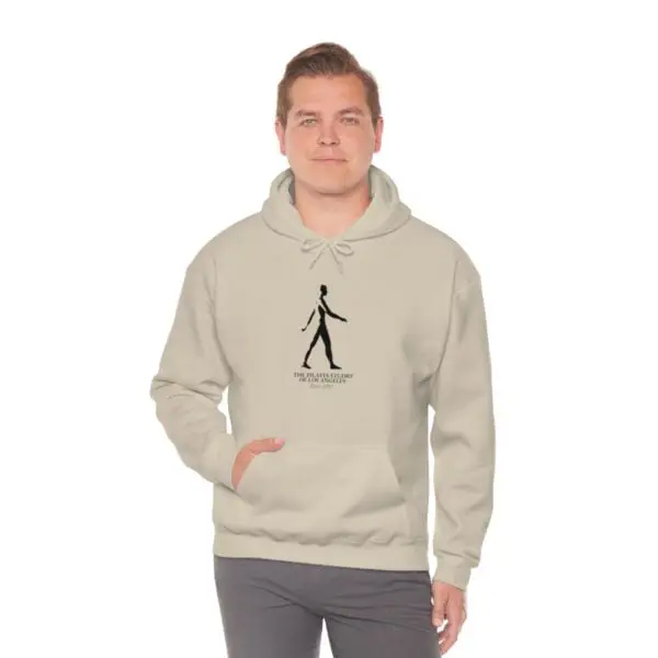 A man is wearing a hoodie with an image of a person walking.