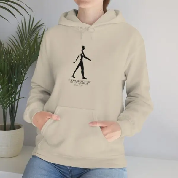 A person wearing a hoodie with a picture of a man walking.