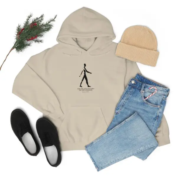 A beige hoodie with a drawing of a person walking.