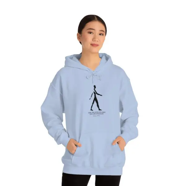 A woman is wearing a light blue hoodie