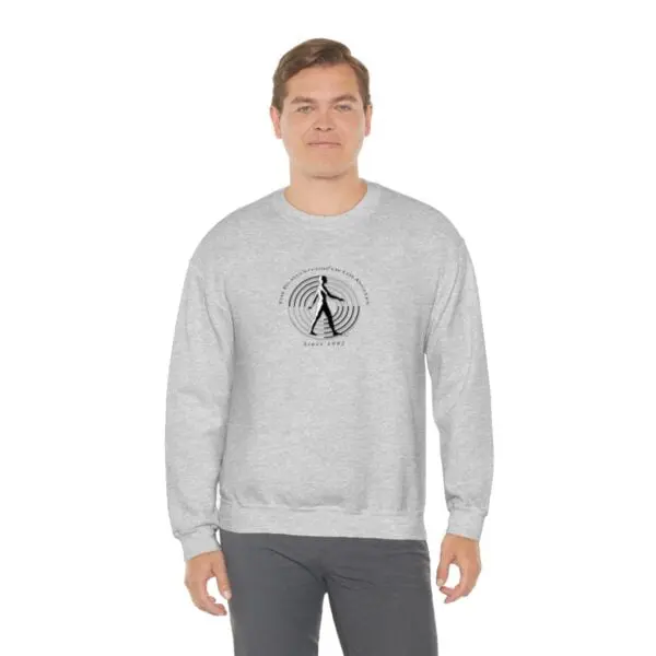 A man wearing a sweatshirt with an image of a person walking.